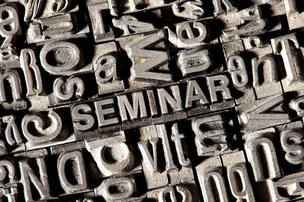 Old lead letters forming the word SEMINAR