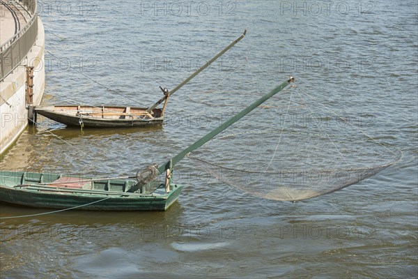 Two boats with old-fashioned nets in the center of Stockholm