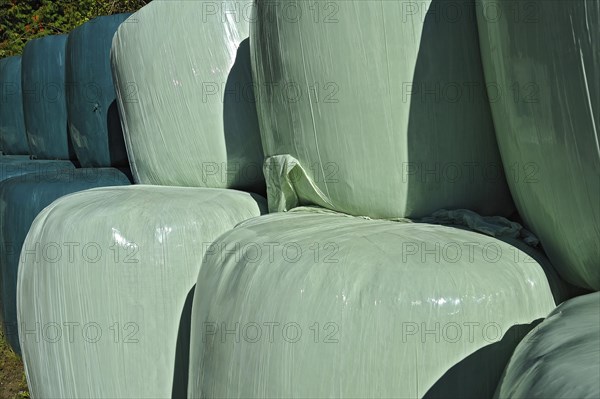 Hay bales wrapped in green plastic sheeting