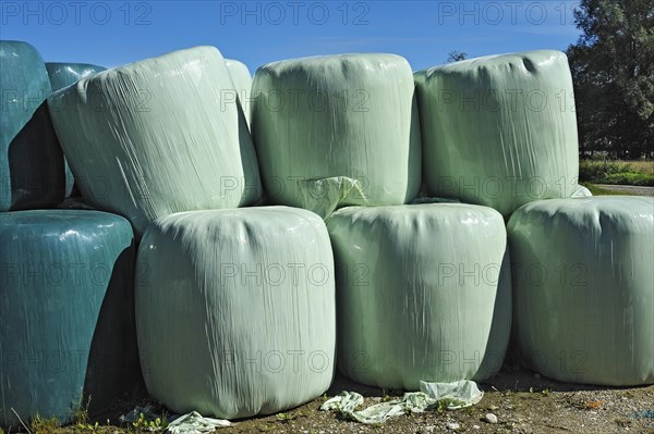 Hay bales wrapped in green plastic sheeting