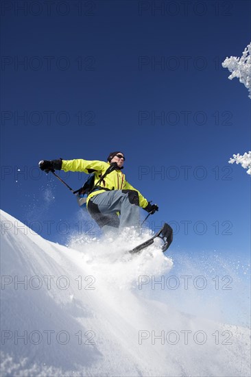 Snowshoe hiker jumping