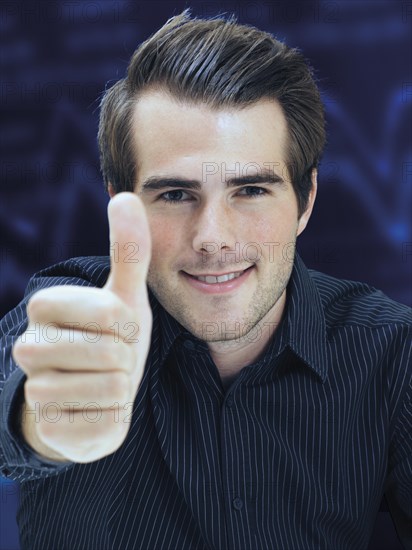 Businessman giving thumbs-up