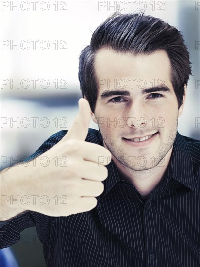 Businessman giving thumbs-up