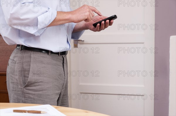 Businessman working at home using a smartphone