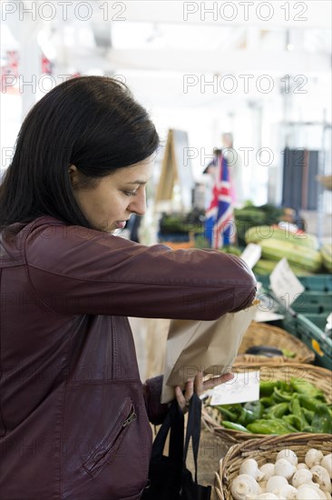 Woman buying vegetables in a local market