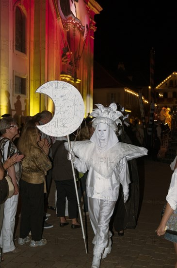 Parade of mask wearers in front of the historic municipal church