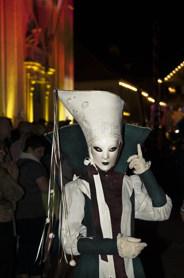 Mask wearer during the parade in front of the historic municipal church