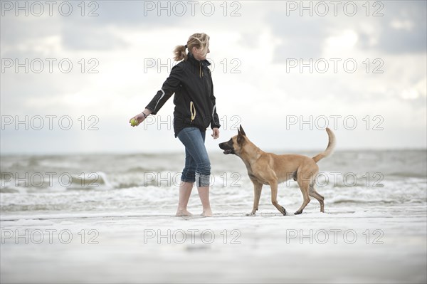 Woman playing with a Hollandse Herdershond