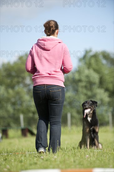 Woman longeing a mixed-breed dog