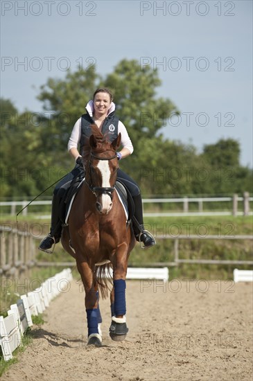 Woman riding a galloping Hanoverian horse