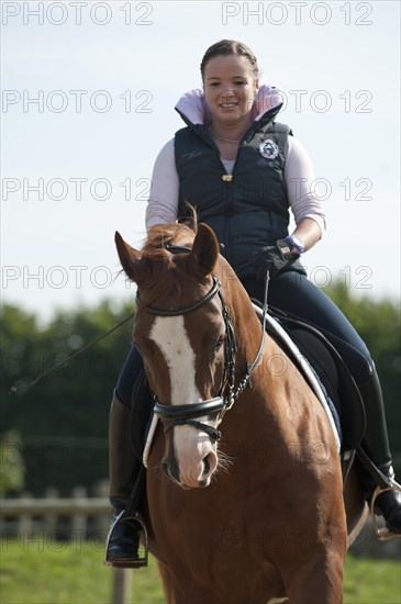 Woman riding a Hanoverian horse