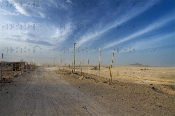 Main road of the salt workers settlement at Afdera during a sandstorm
