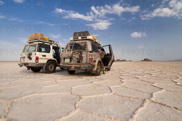 SUVs parked on the salt formations of the Ass Ale salt lake in the Danakil Depression