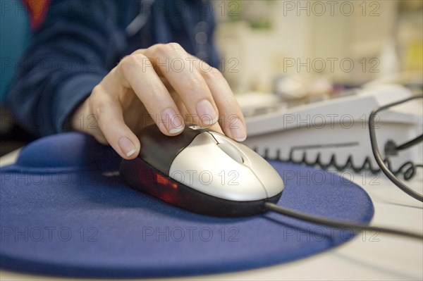 Hand on a computer mouse