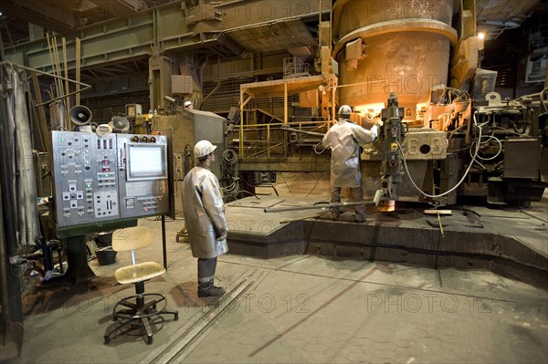 Liquid steel pouring from the ladle into the casting