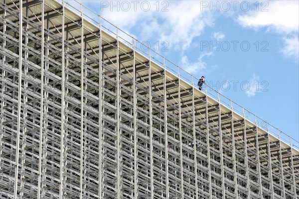 Worker on the roof of a high bay warehouse during construction