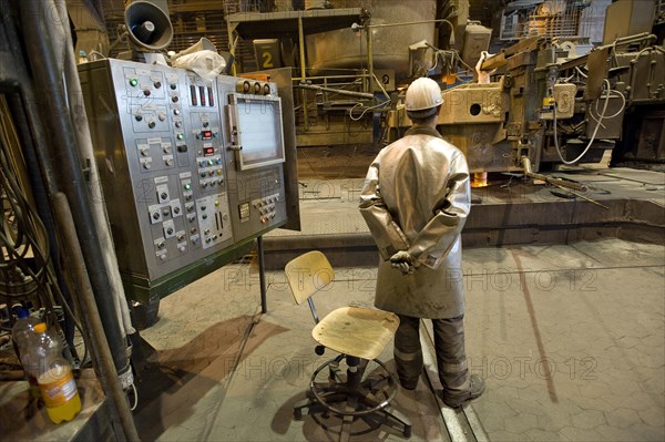 Liquid steel pouring from the ladle into the casting