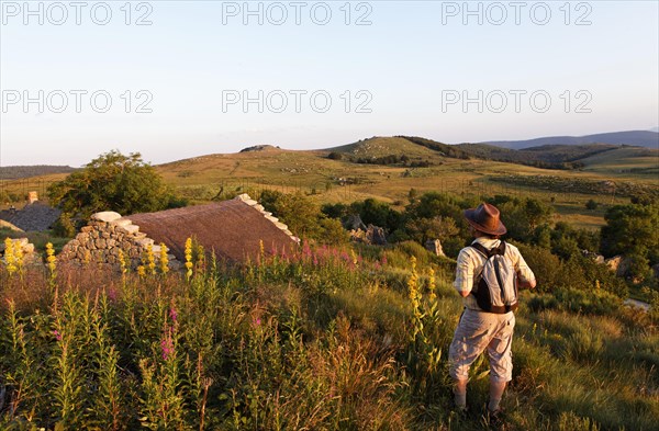 Hiker at water mill in the village of L'Hopital