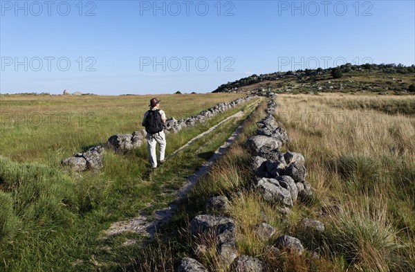 Hiker on hiking trail GR7 in L'Aubaret village