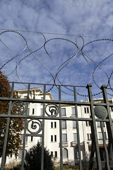 Barbed wire around an abandoned building