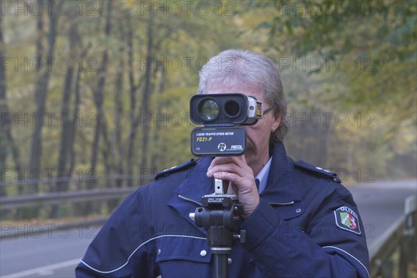 Policeman operating a radar gun