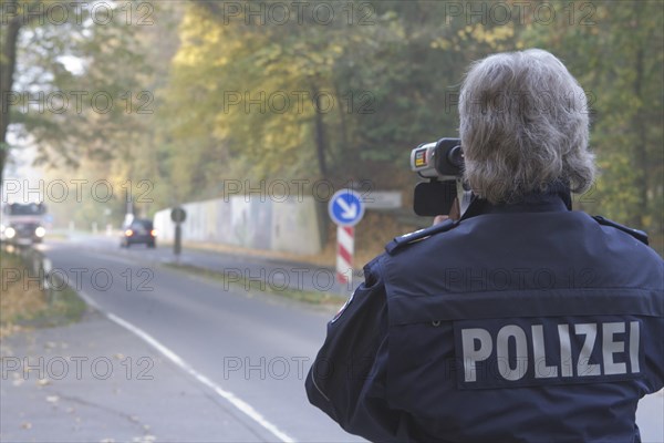 Policeman operating a radar gun