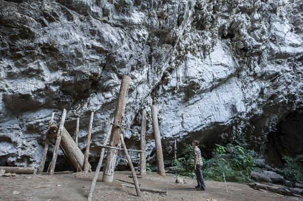 Woman admiring thousands of years old teak coffins