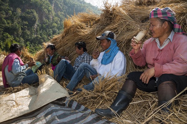 People from the Shan or Thai Yai ethnic minority are drinking tea from a bamboo cup