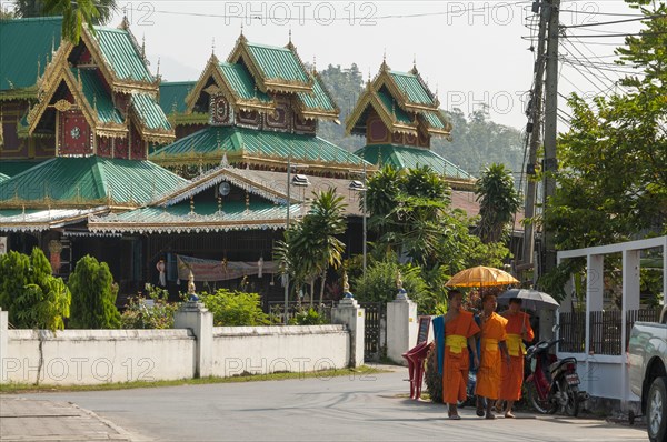 Buddhist monks with parasols