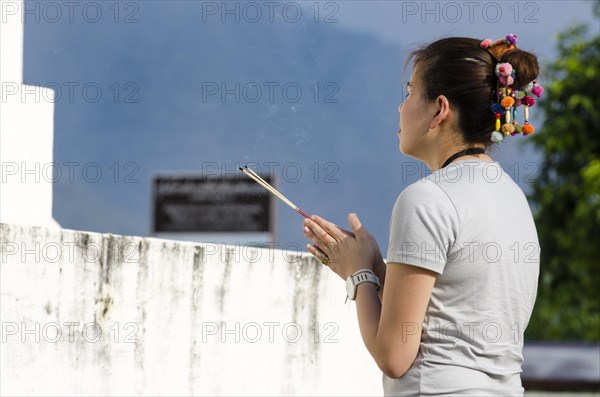 Woman holding incense sticks