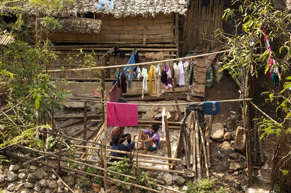 Young people sitting outside a hut