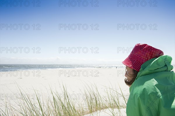 A woman sitting on the beach