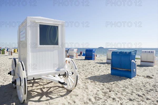 Colourful roofed wicker beach chairs and a historical cabana on the beach near Wyk