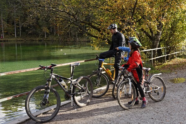 Father and children riding mountain bikes