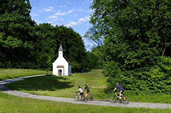 Father and children cycling