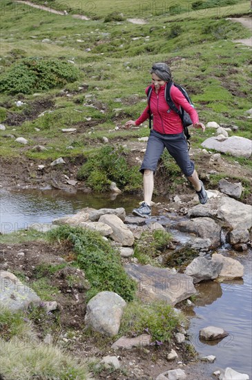 Hiker at the Raschotz or Rasciesa mountain pasture near St. Ulrich