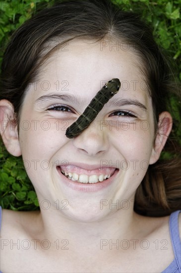 Girl with a caterpillar on her face