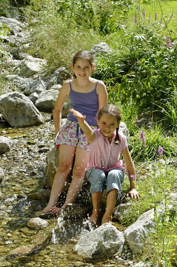 Girls playing and splashing with water