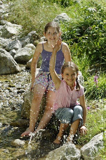 Girls playing and splashing with water