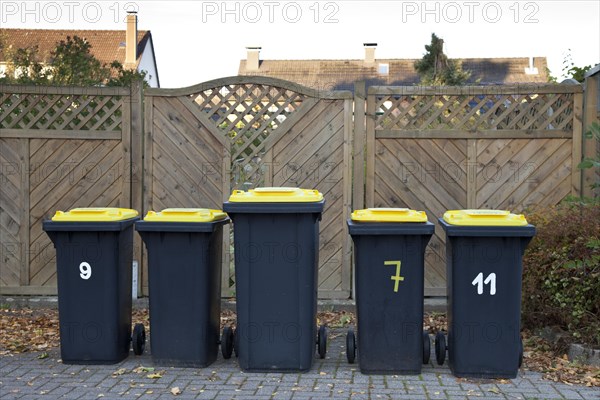 Recycling bins standing on the side of the road