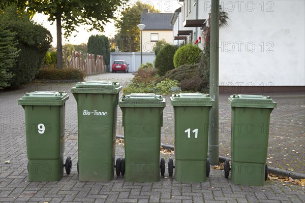 Organic waste collection bins standing on the side of the road