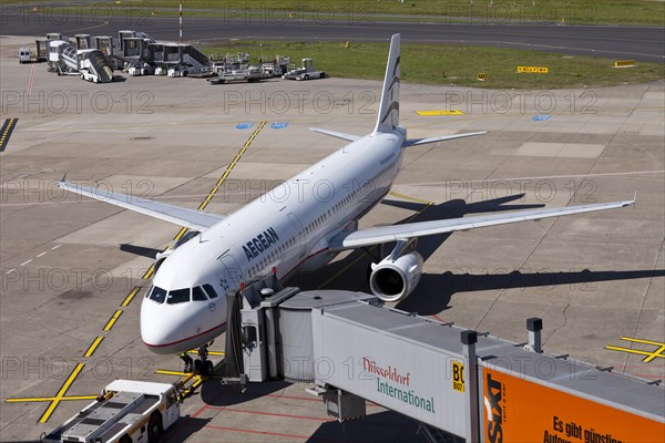 AegeanAir SX-DGA Airbus A 321-232 aircraft being attached to a jetway or passenger boarding bridge on the airport apron