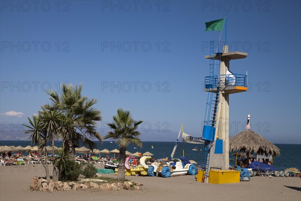 Palm trees and the tower of the lifeguards on Hawaii Playa beach