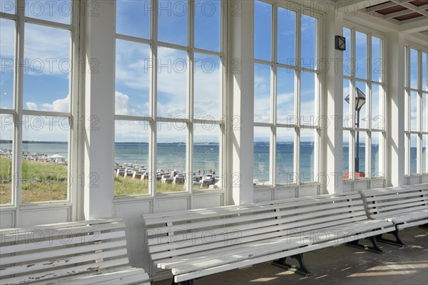 Looking through the window of the pavilion of the Kurhaus spa building towards the Baltic Sea and the beach