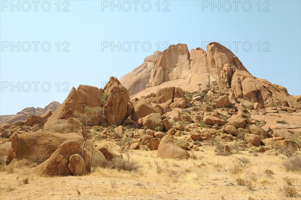 Savannah landscape with granite rocks and Spitzkoppe Mountain