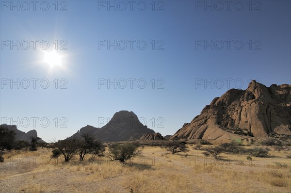 Savannah landscape with granite rocks and Spitzkoppe Mountain