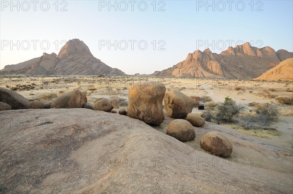 Savannah landscape at sunset with rock formations