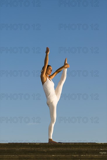 Young woman practising Hatha yoga