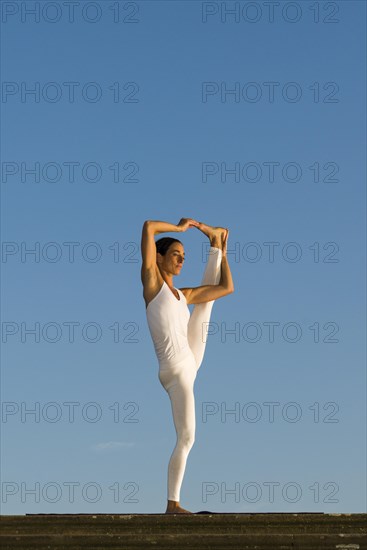 Young woman practising Hatha yoga