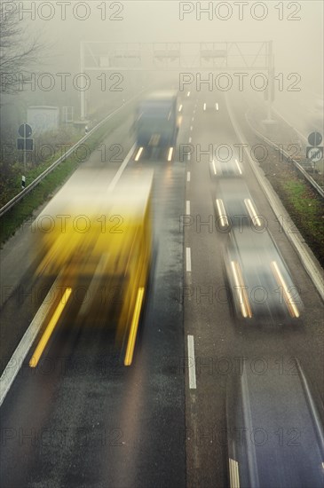 Rush hour on a motorway with early morning fog